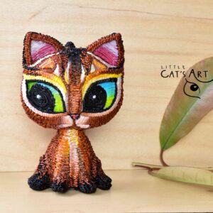 Abyssinian cat art figurine with blue-green eyes