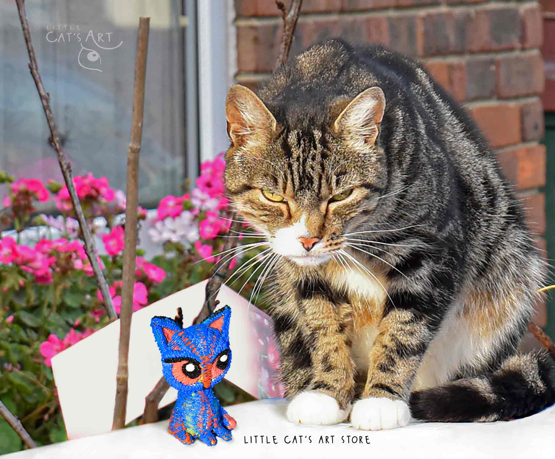 Blue cat figurine and Tabby cat