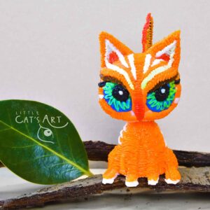Ginger cat figurine with big blue-green eyes