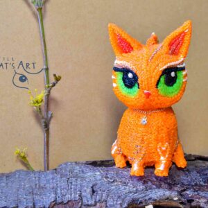 Ginger cat figurine with big green eyes