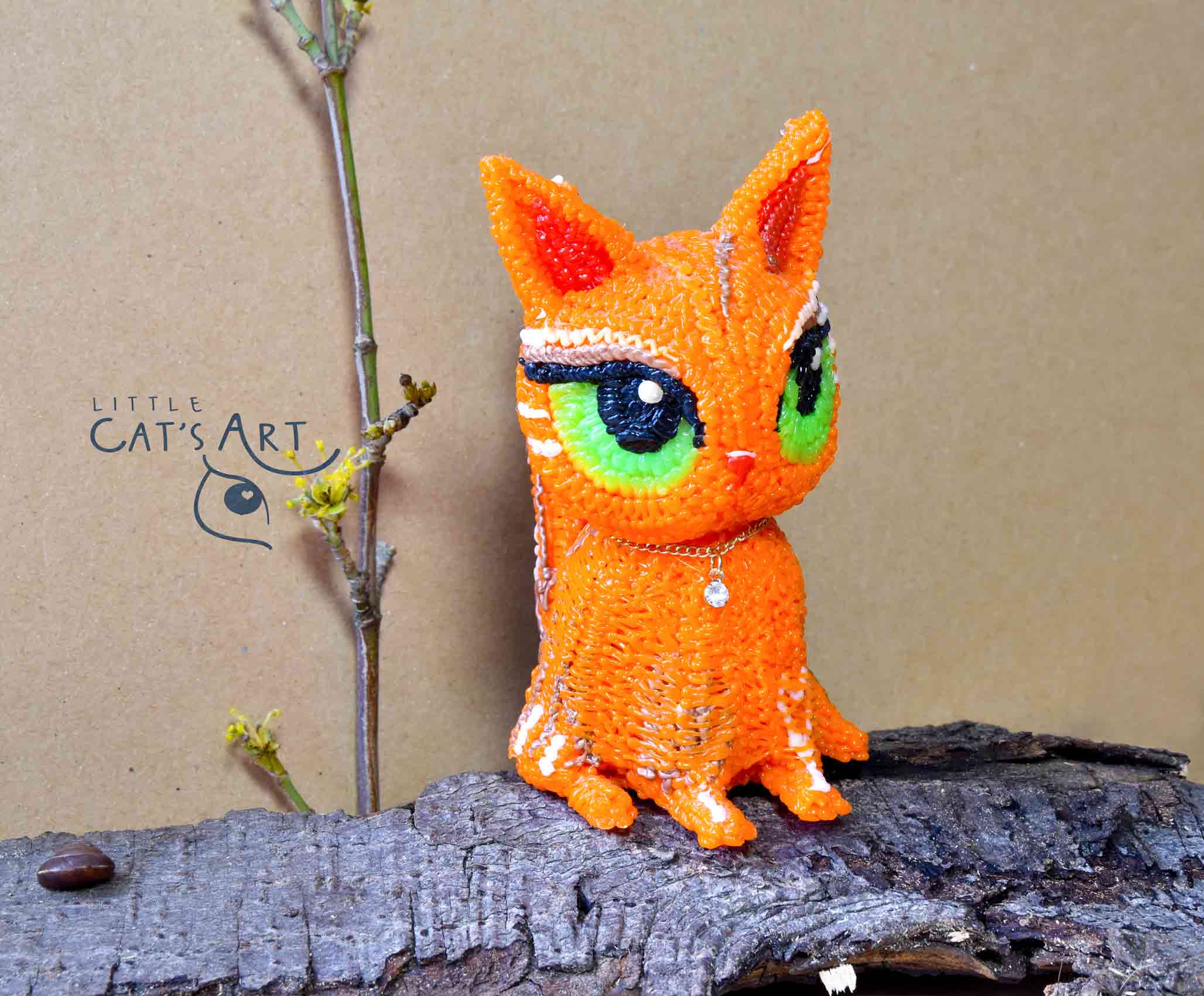 Ginger cat figurine with big green eyes
