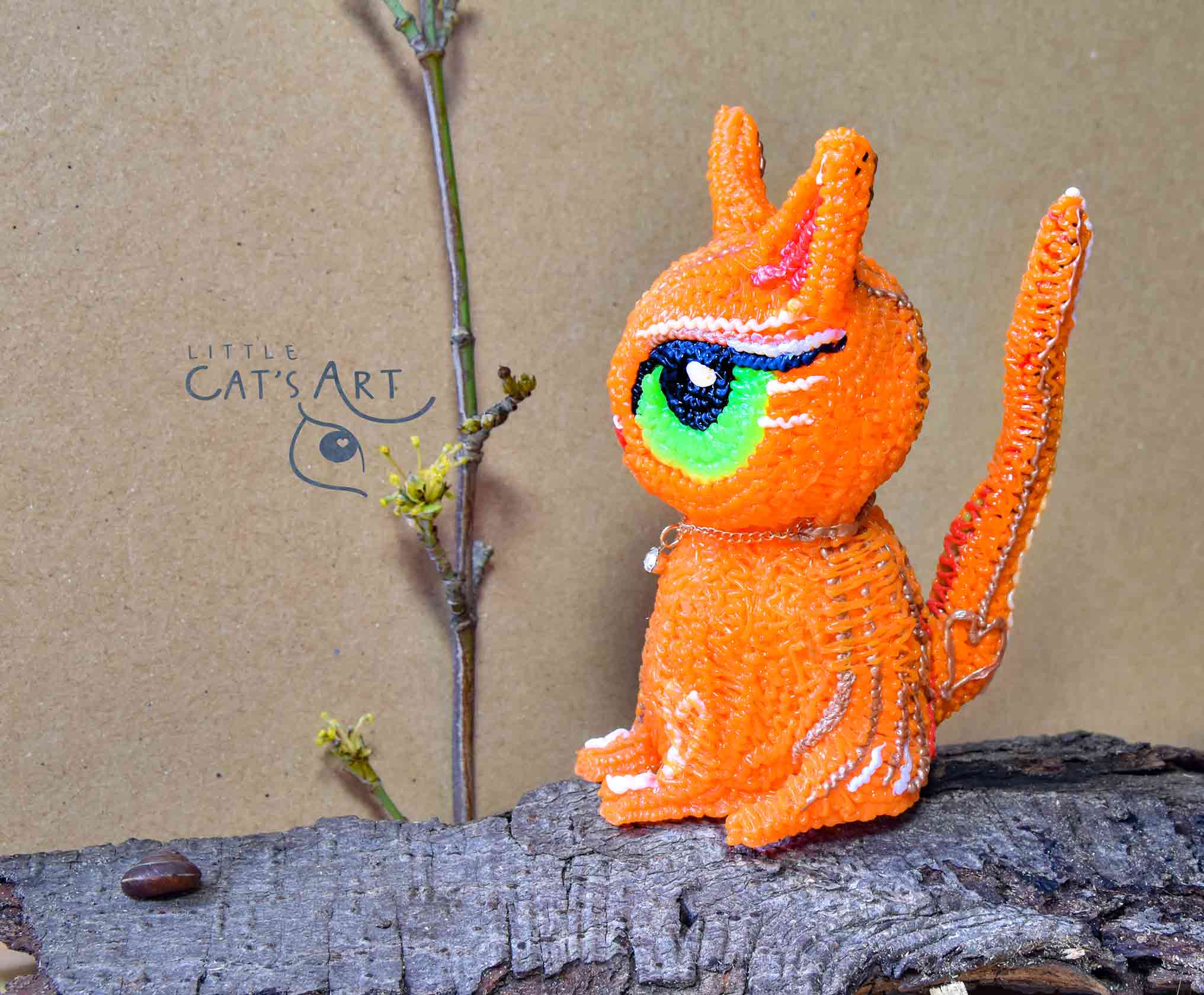 Ginger cat figurine with big green eyes