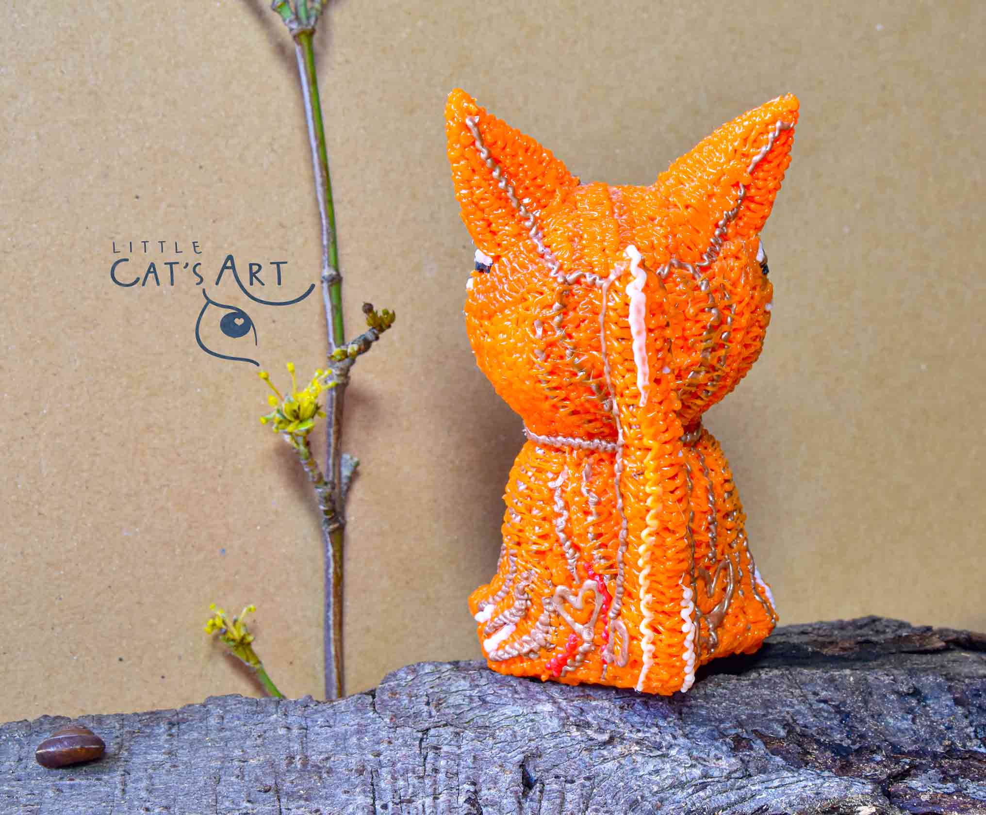 Ginger cat figurine with big green eyes