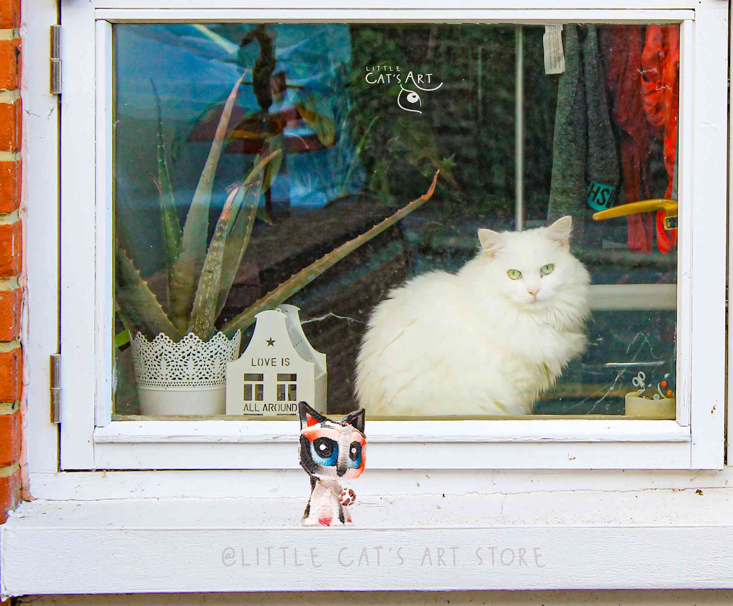 White leopard cat figurine and white cat