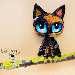 Tortoiseshell cat ornament with blue eyes