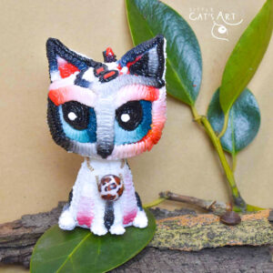 White leopard cat figurine with blue eyes