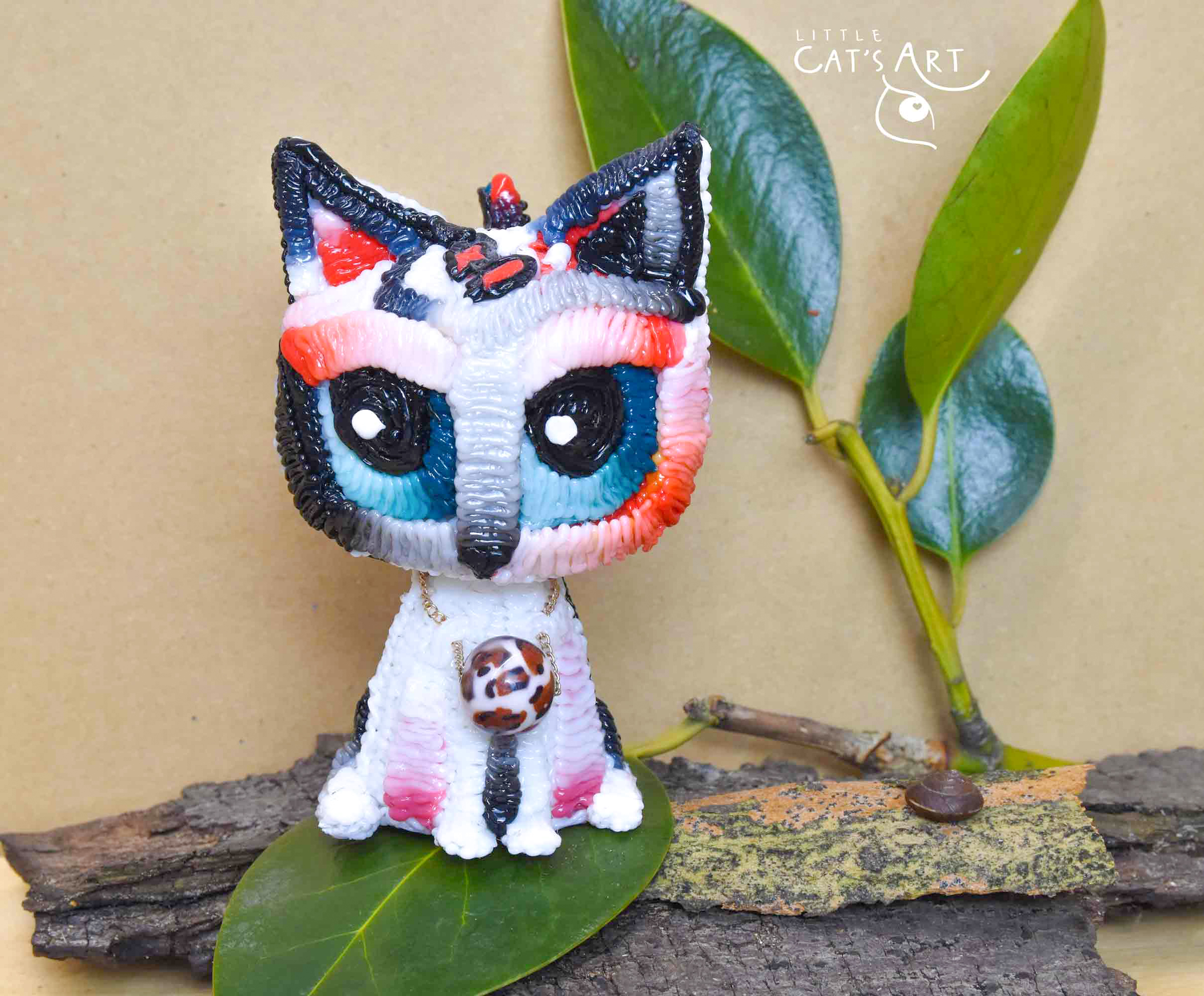 White leopard cat figurine with blue eyes