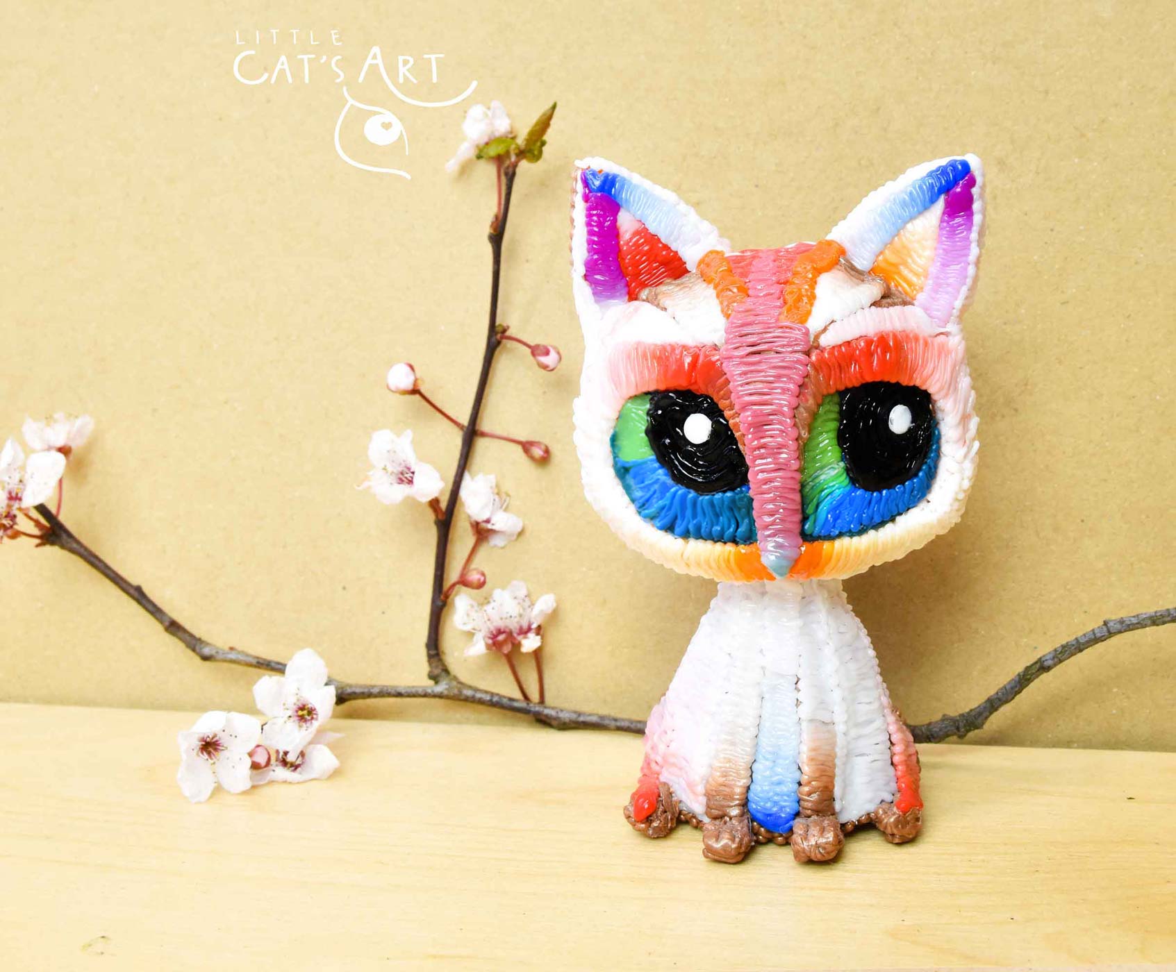 White rainbow cat figure
