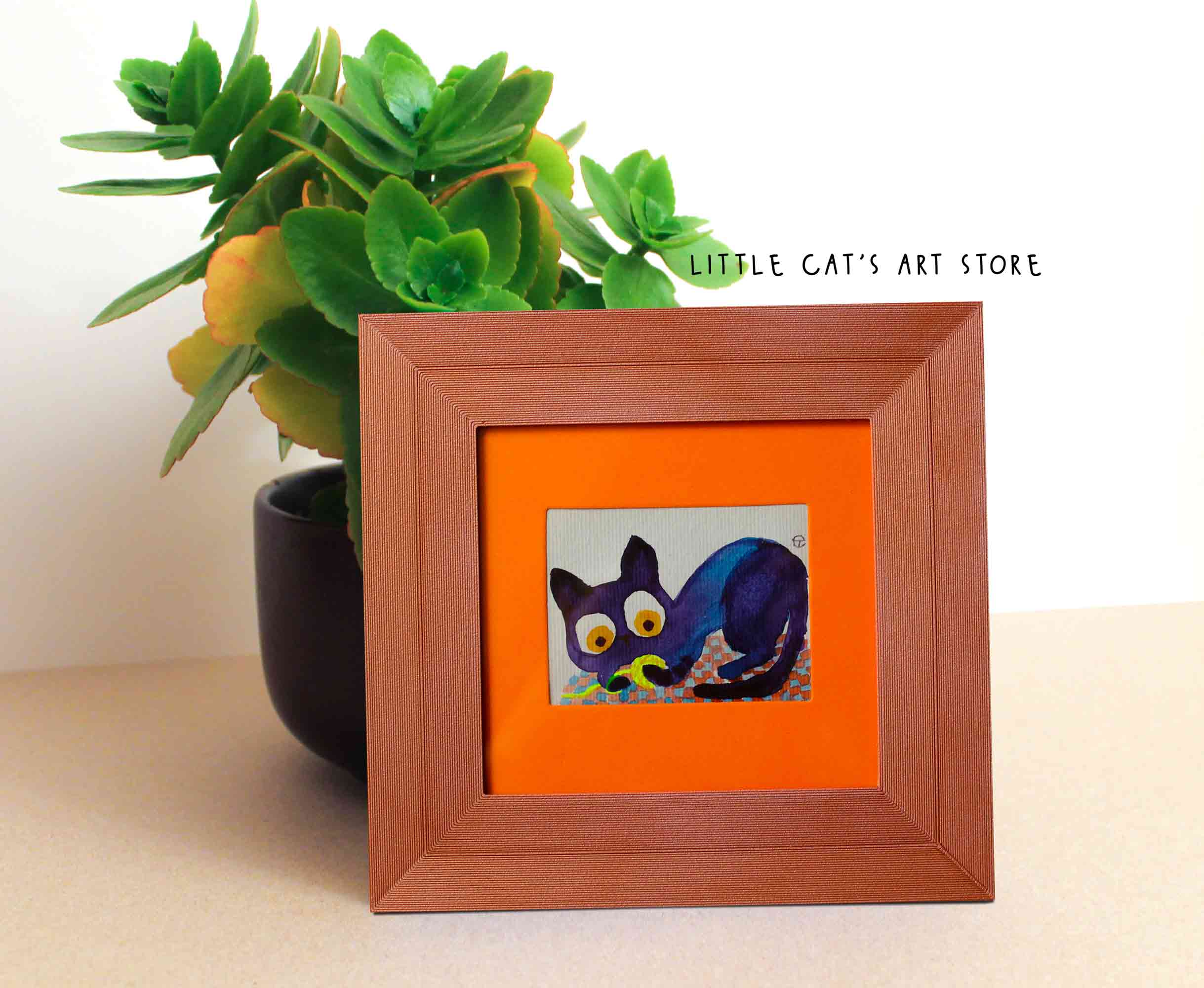 Tiny black cat playing with electric yellow yarn painting
