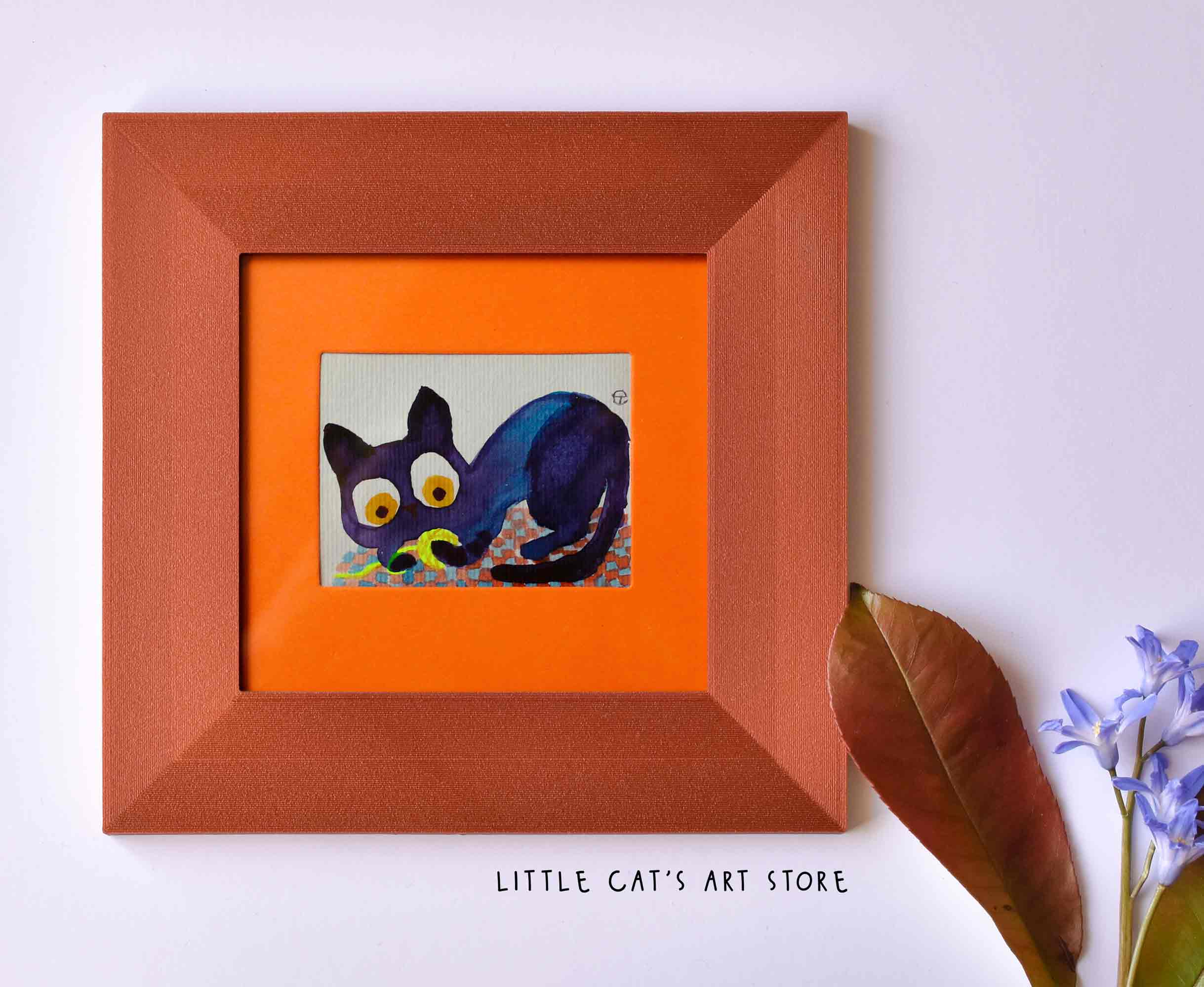 Tiny black cat playing with electric yellow yarn wall art