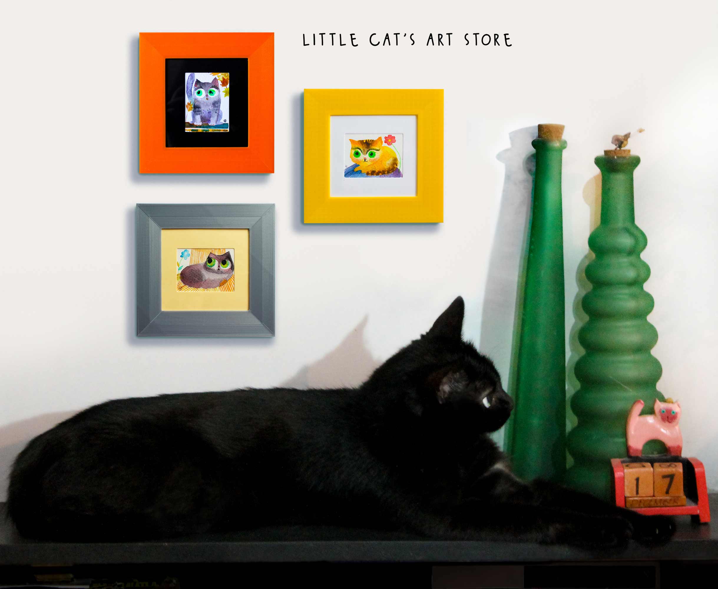 Set of three watercolour paintings and a black cat