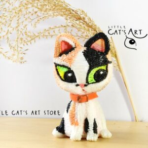Calico kitten collectible figurine with green eyes