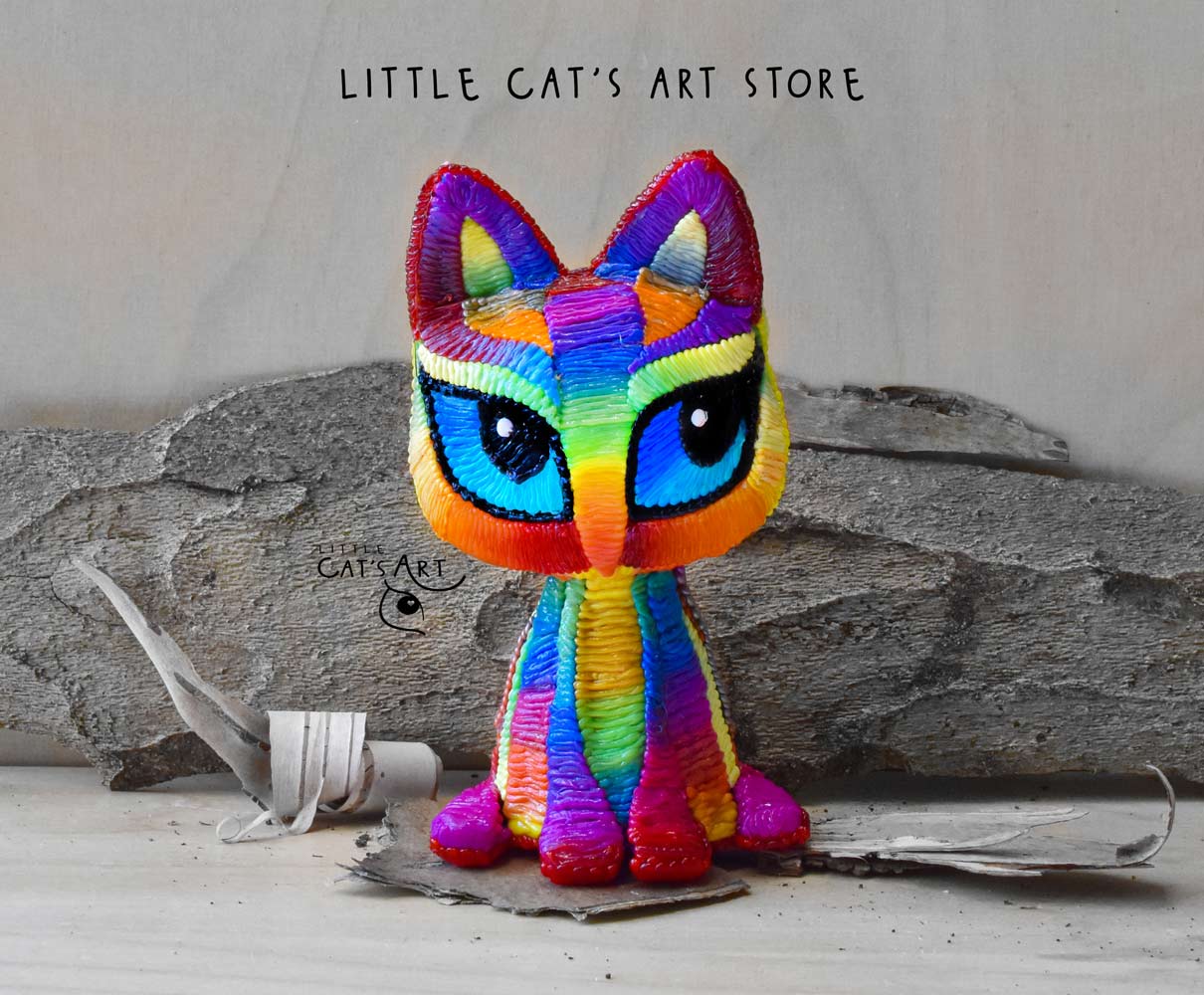 Rainbow cat figurine with blue eyes