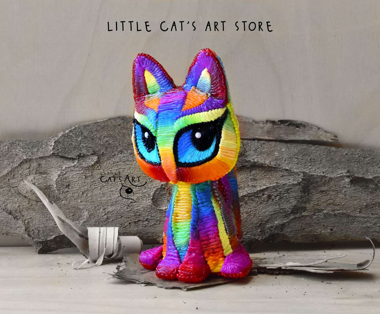 Rainbow cat figurine with blue eyes