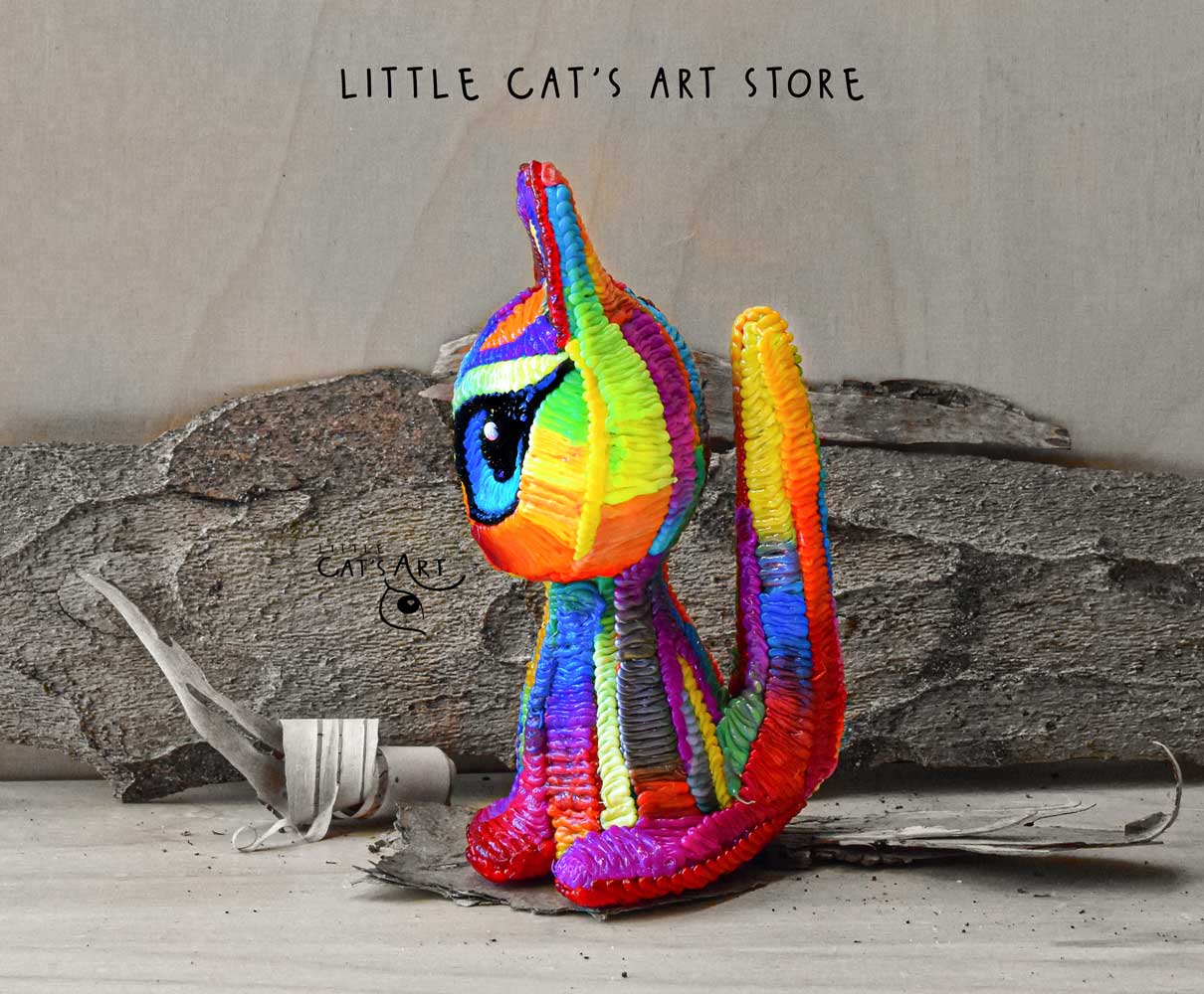 Rainbow cat figurine with blue eyes