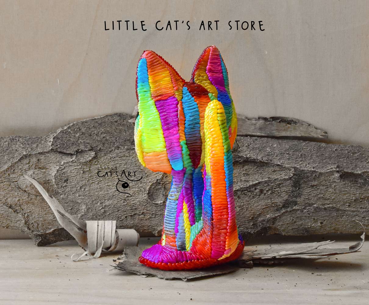 Rainbow cat figurine with blue eyes