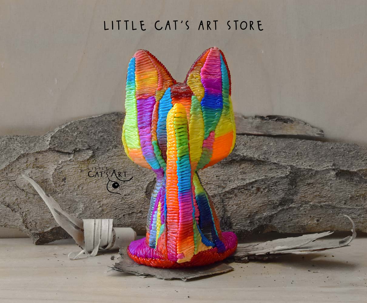 Rainbow cat figurine with blue eyes