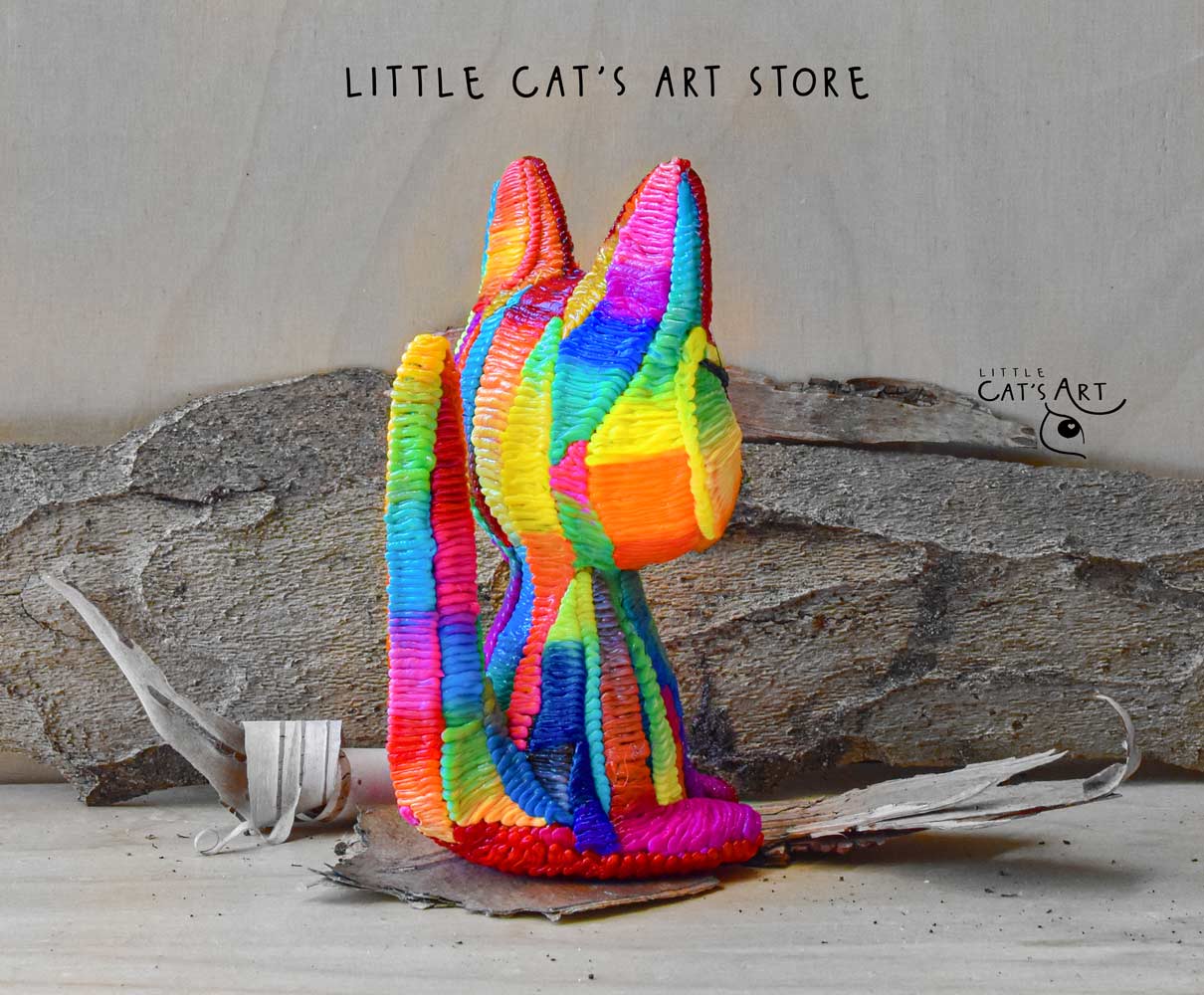 Rainbow cat figurine with blue eyes