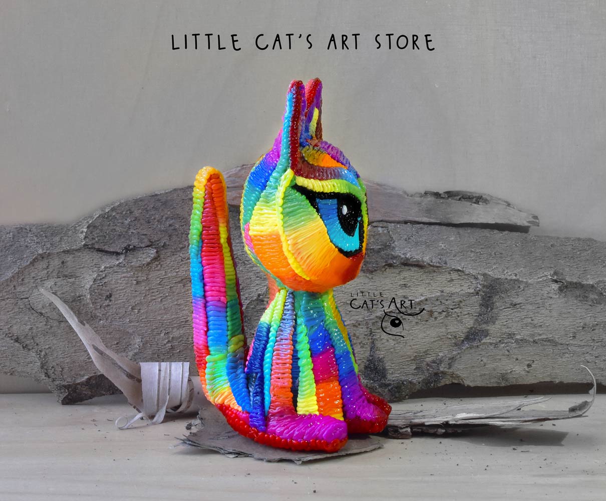 Rainbow cat figurine with blue eyes