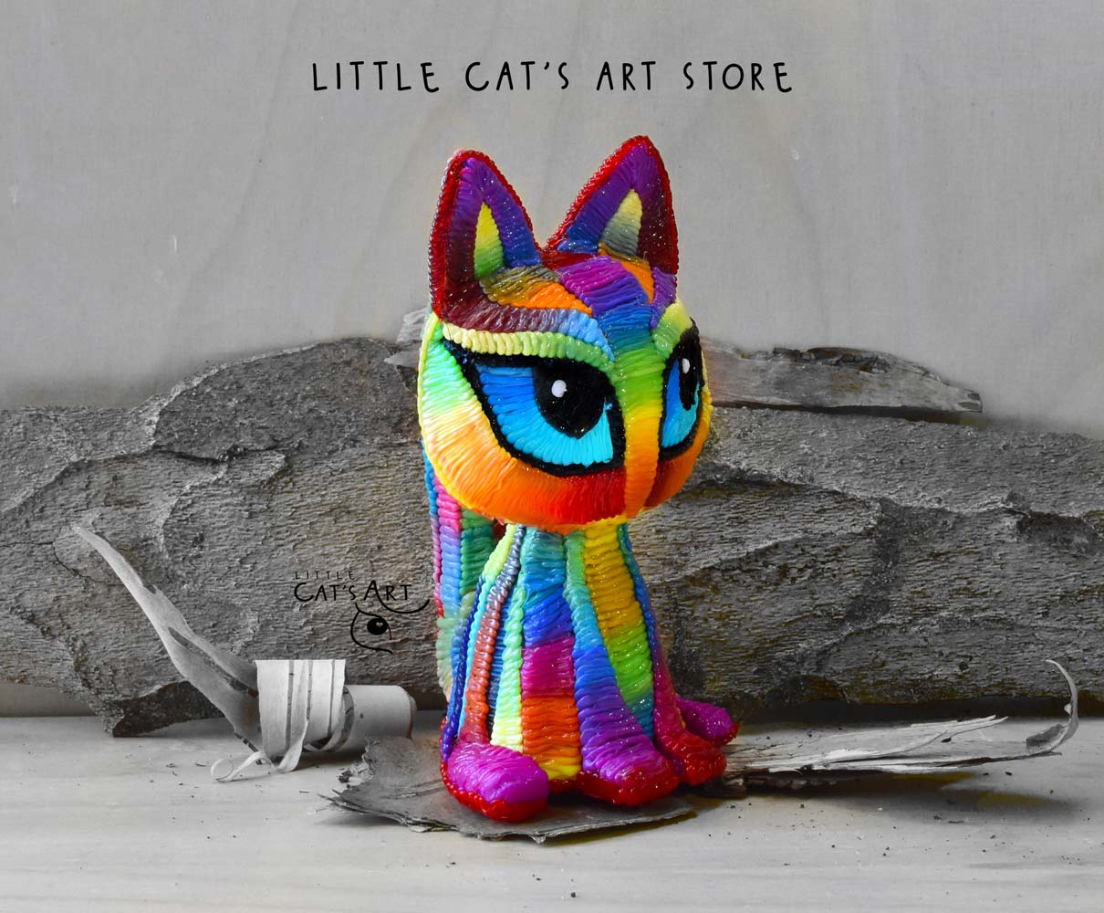 Rainbow cat figurine with blue eyes