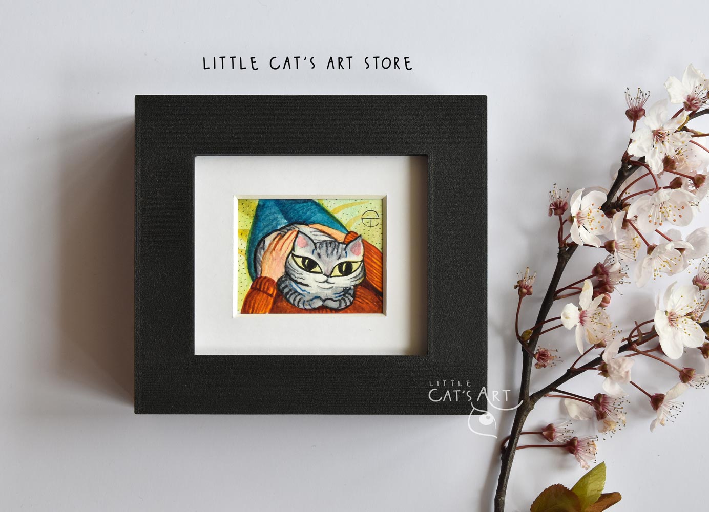 Grey tabby cat in owner's lap painting