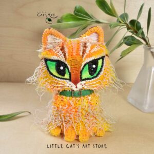 Fluffy ginger cat figurine with green eyes