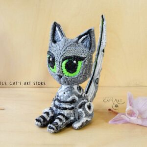 Grey tabby cat figurine with green eyes
