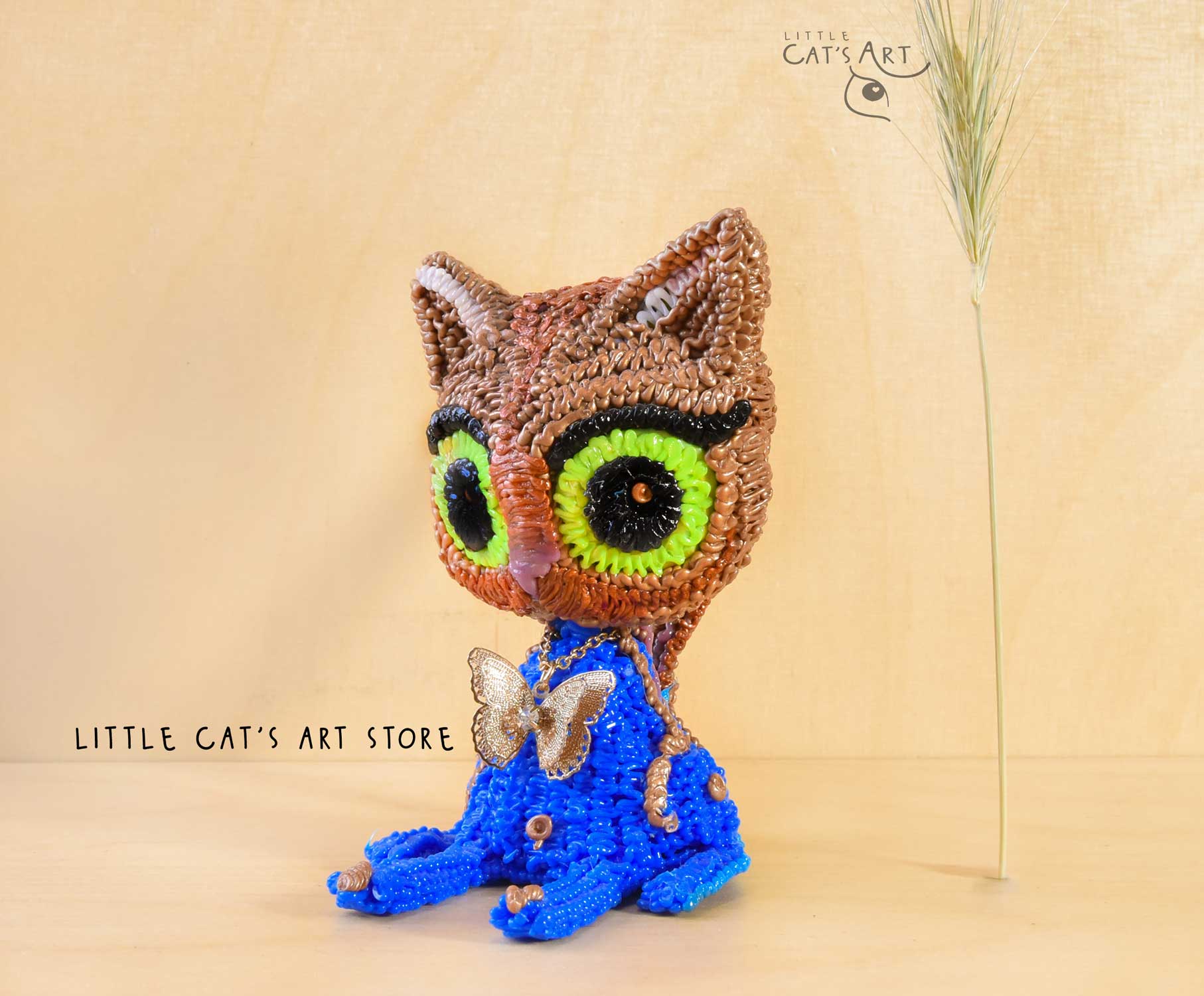 Copper and blue cat figurine with surprised face and butterfly necklace