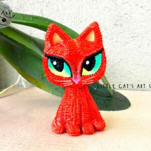 Red kitty figurine with green eyes