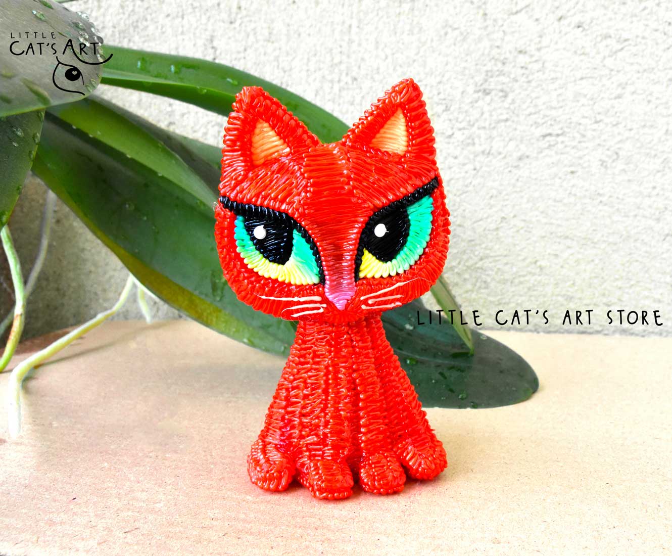 Red kitty figurine with green eyes
