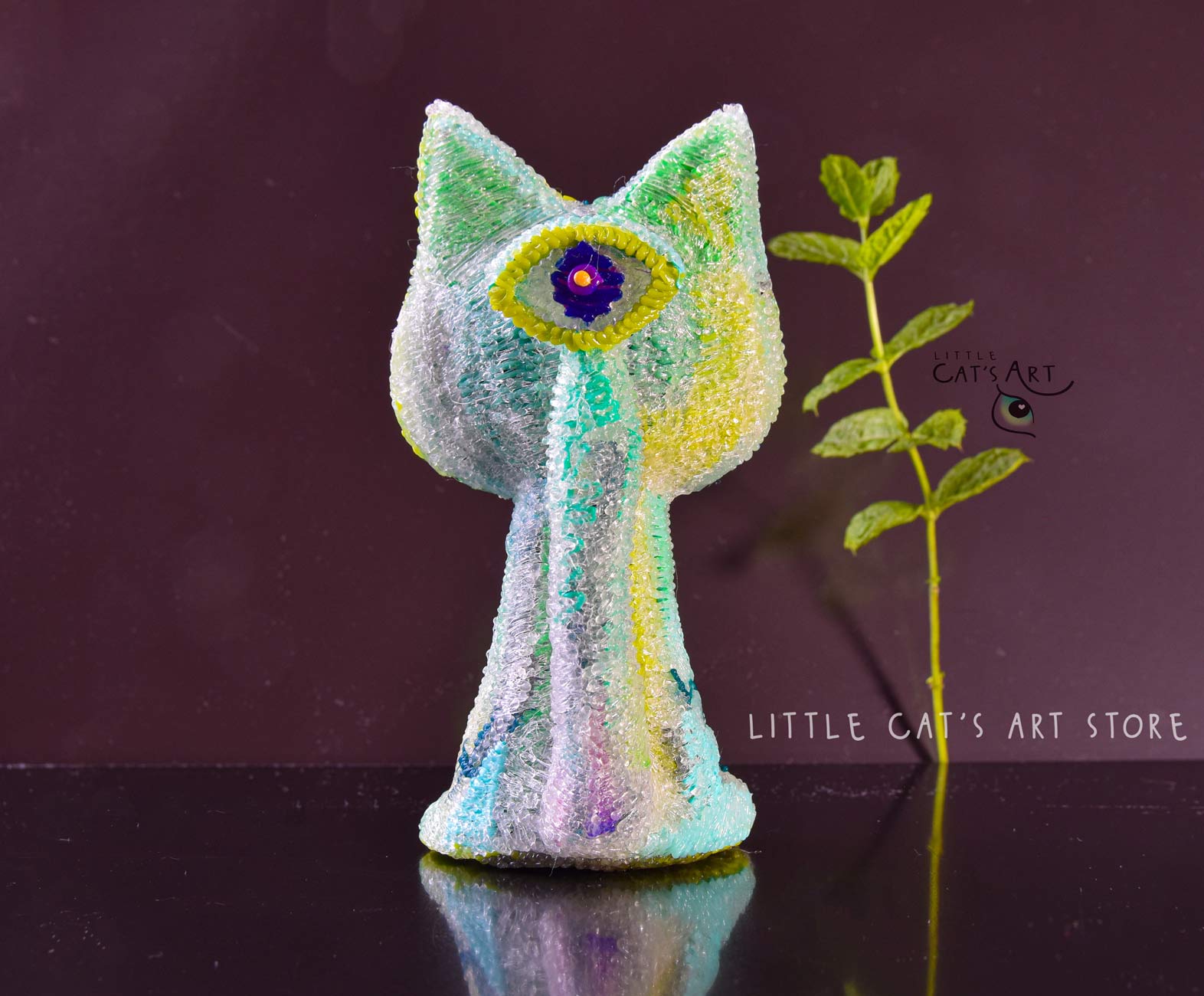 Green mint alien cat figurine with 1 eye on the tail