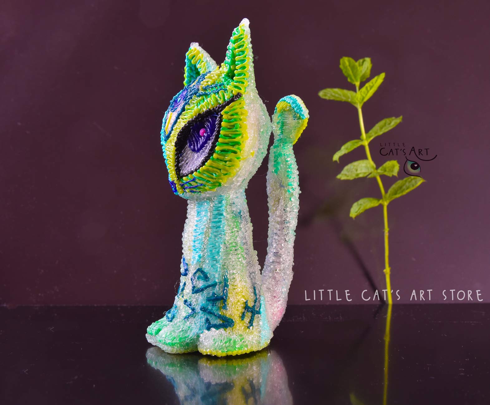 Green mint alien cat figurine with 3 eyes
