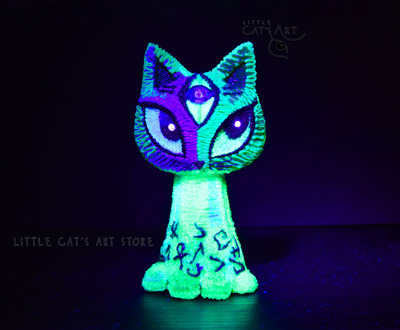Mint green alien cat figurine under UV light