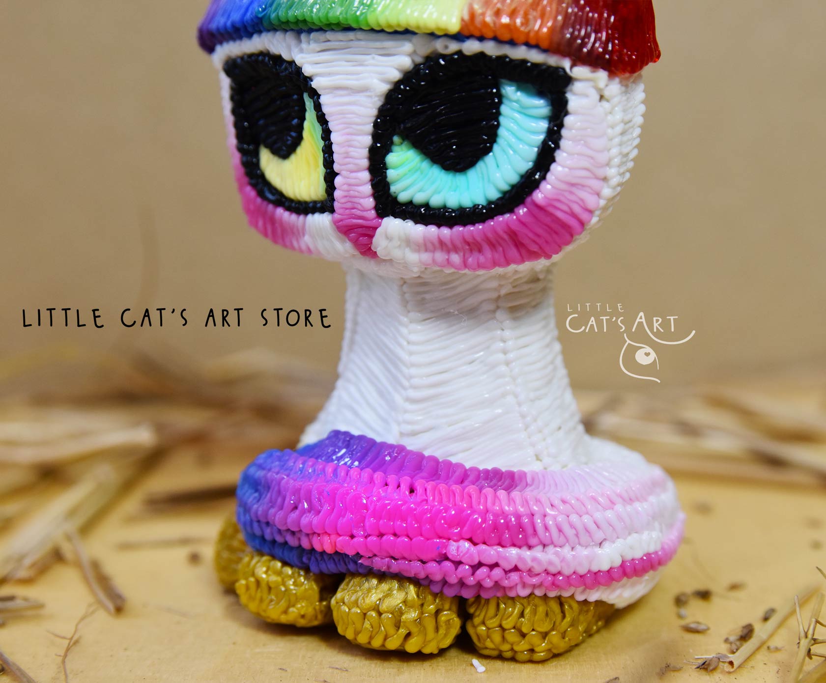 Easter bunny cat figurine with rainbow hat