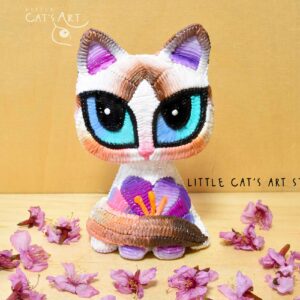 White Ragdoll cat figurine with purple crocus flower decoration