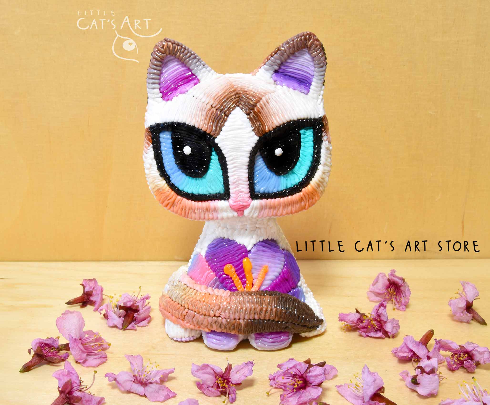 White Ragdoll cat figurine with purple crocus flower decoration