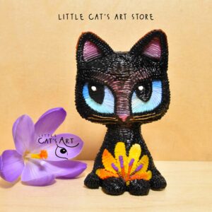 Black cat figurine with blue eyes and yellow flower decoration