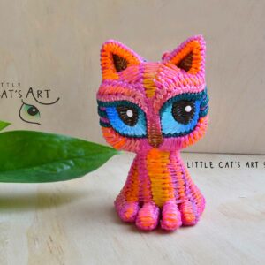 Pink cat figurine with blue eyes