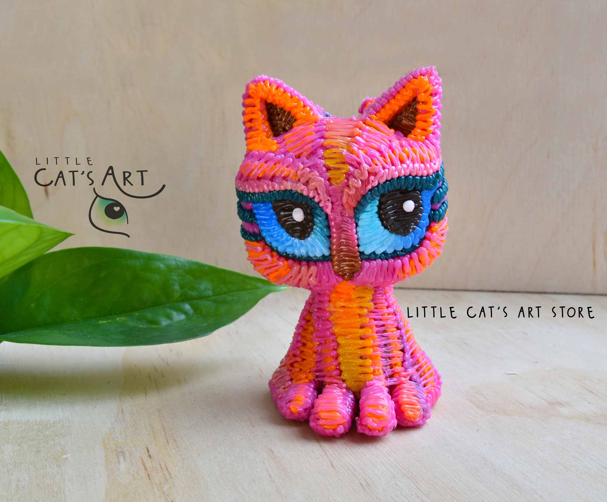 Pink cat figurine with blue eyes