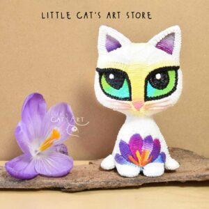 White spring cat figurine with violet crocus flower decoration