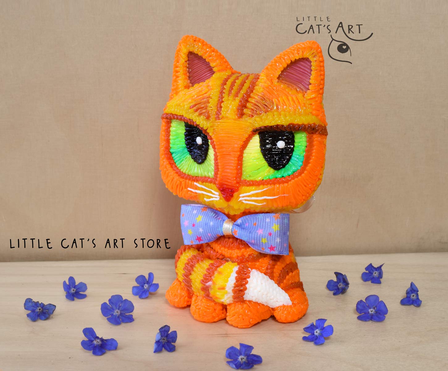 Ginger cat with green eyes wearing a bow tie