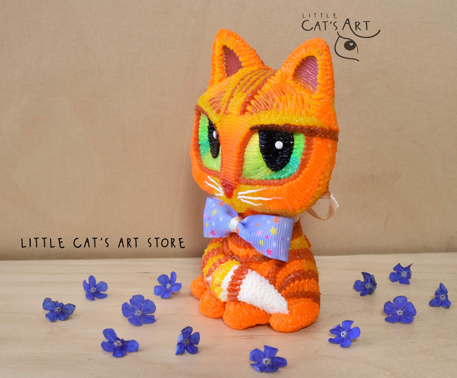 Ginger cat with green eyes wearing a bow tie