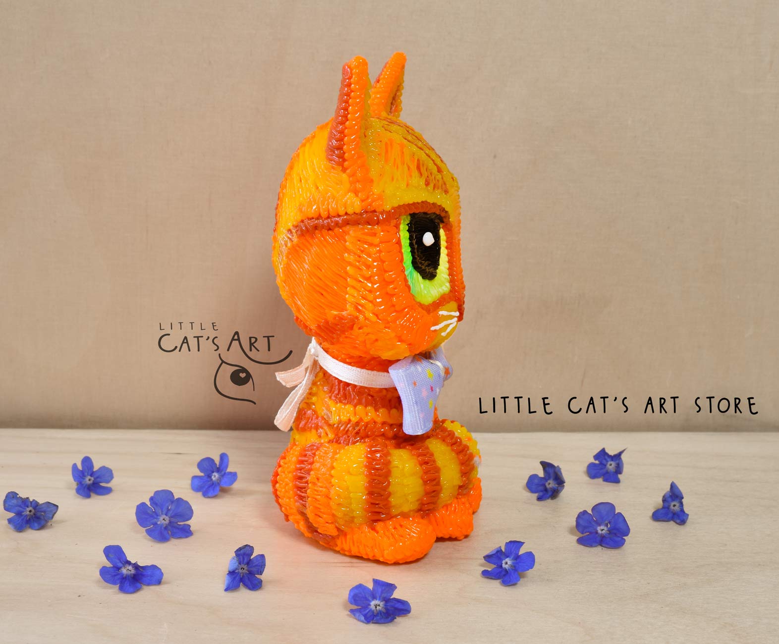 Ginger cat with green eyes wearing a bow tie