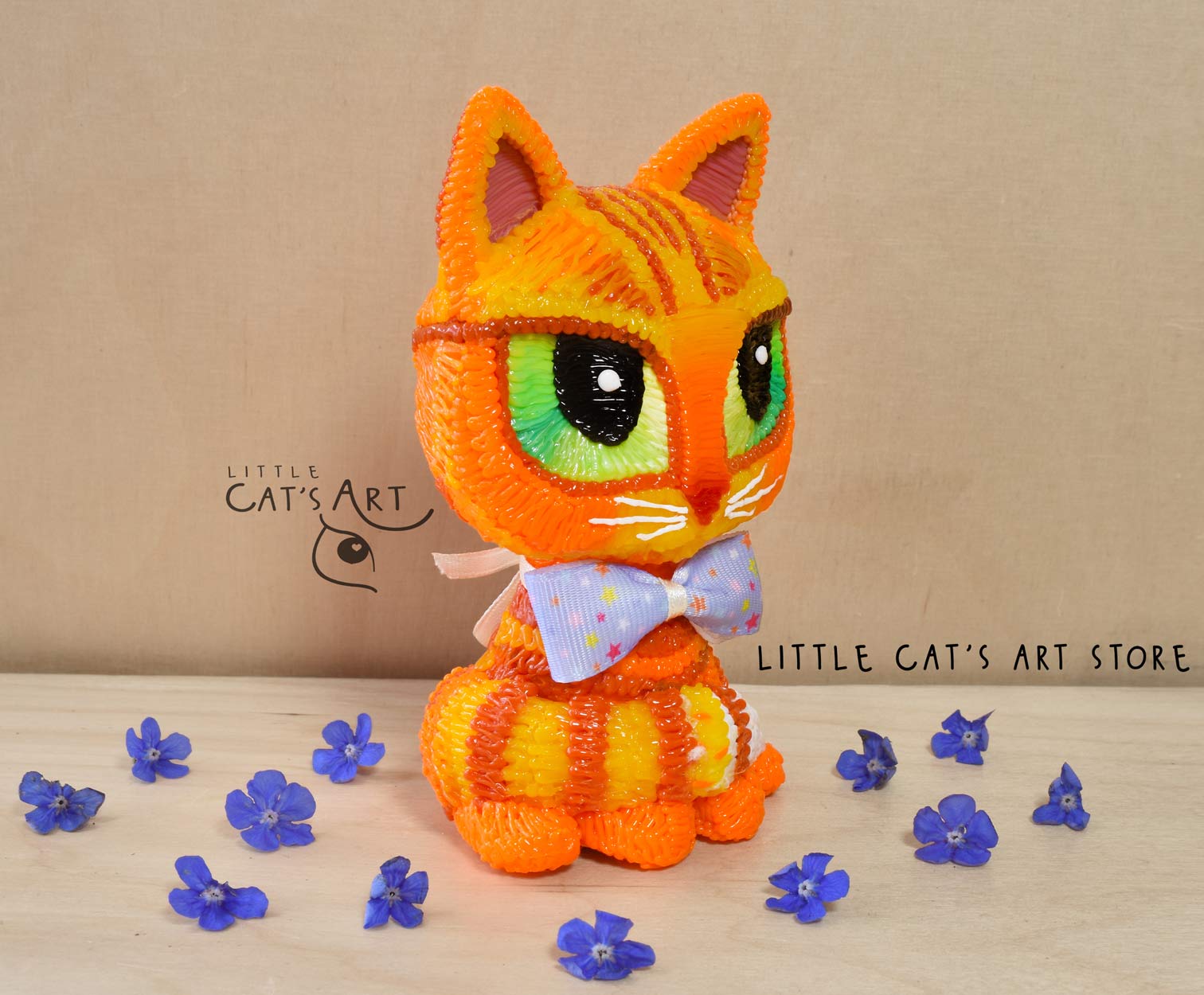 Ginger cat with green eyes wearing a bow tie