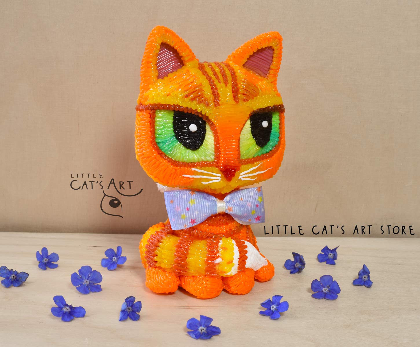 Ginger cat with green eyes wearing a bow tie