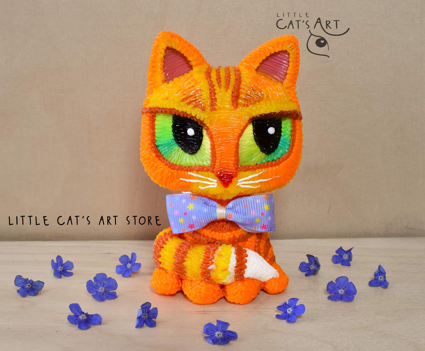 Ginger cat with green eyes wearing a bow tie