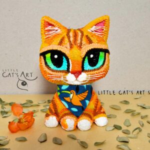 Ginger kitty figurine with green eyes wearing bandana illustrating bird