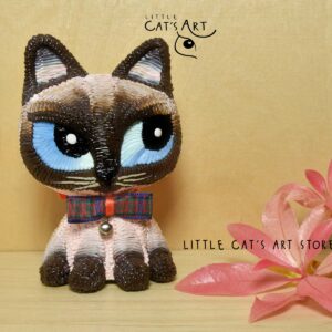 Siamese cat with blue eyes and mini bow tie