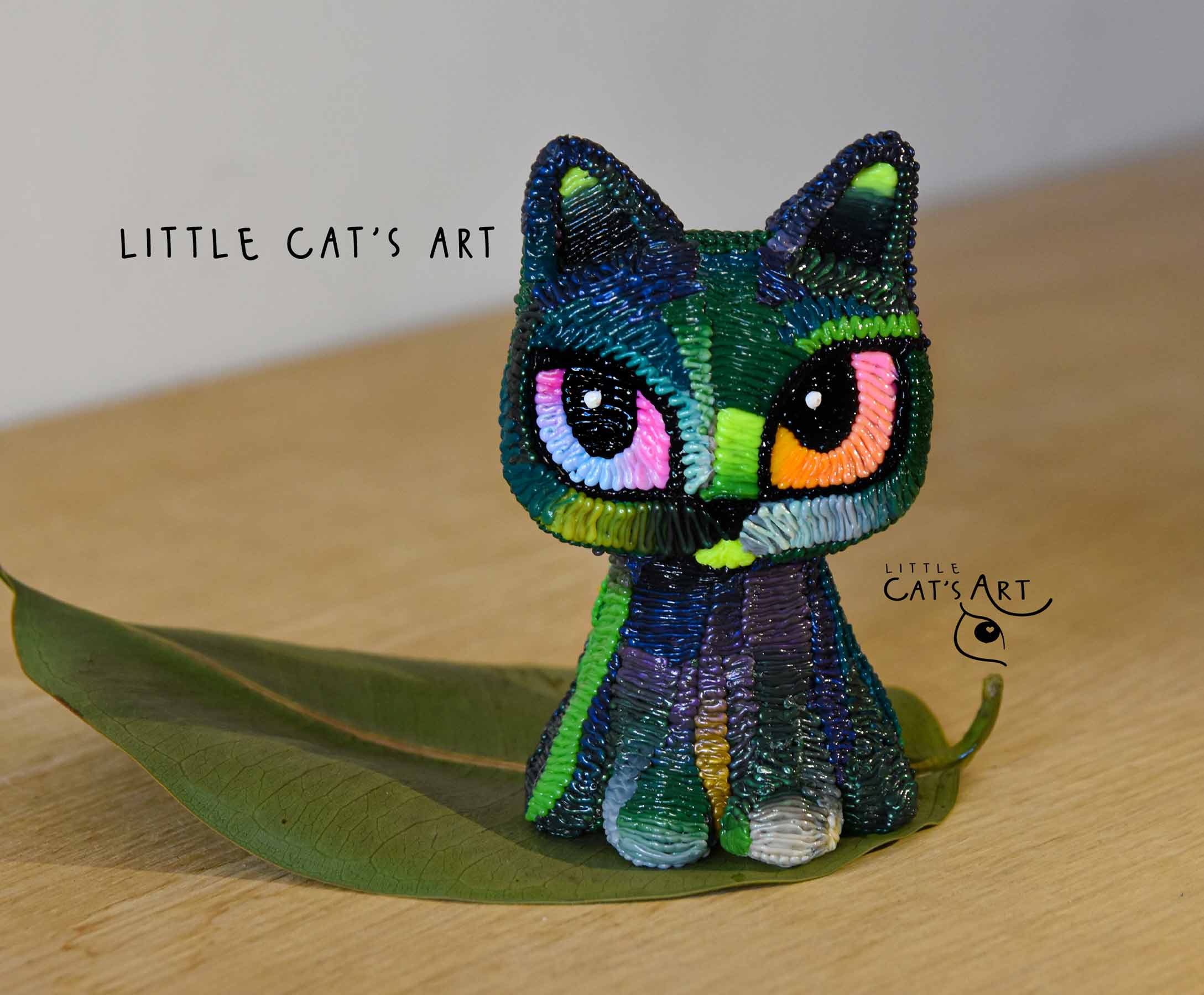 Iridescent green & purple cat figurine