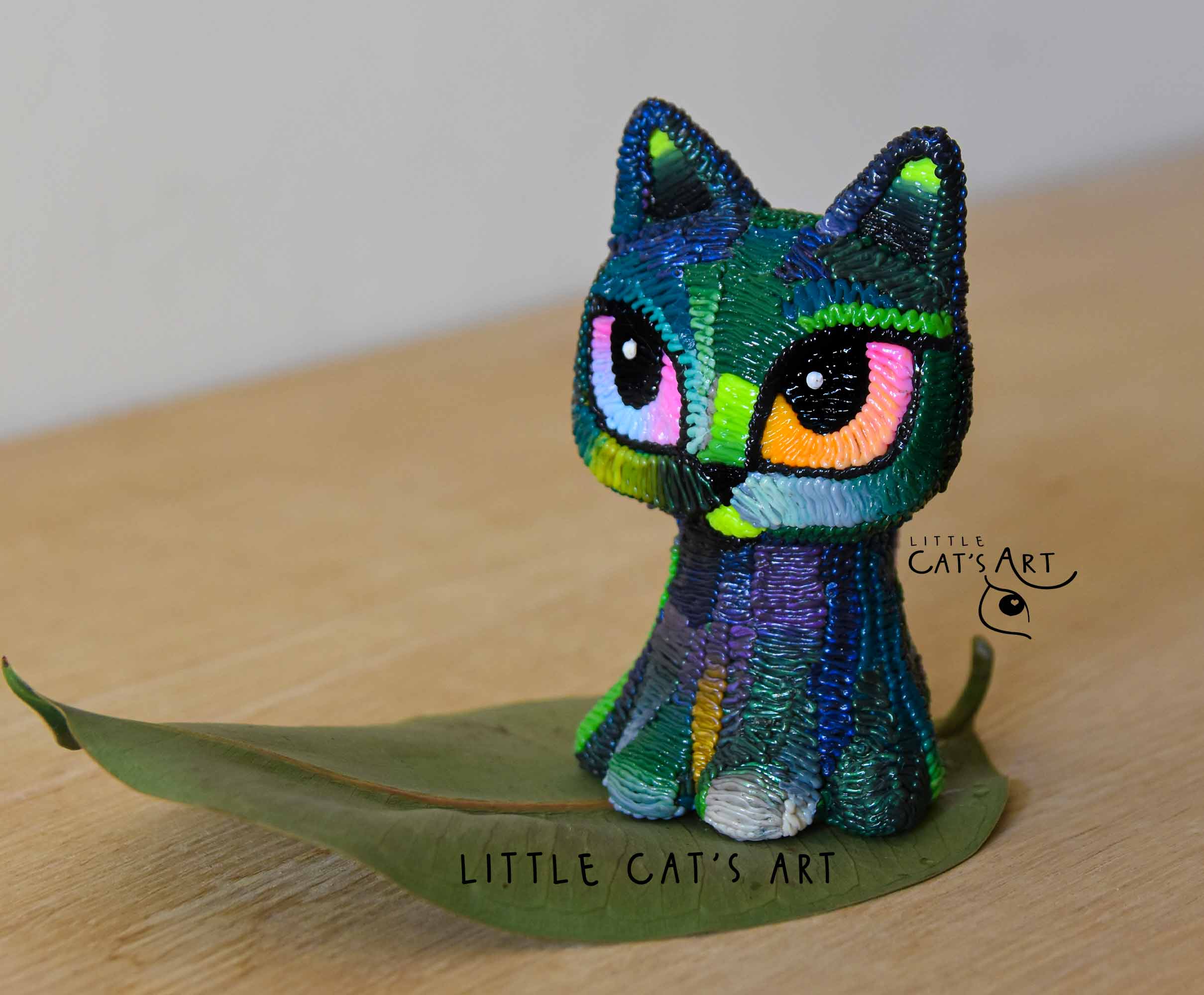 Iridescent green & purple cat figurine